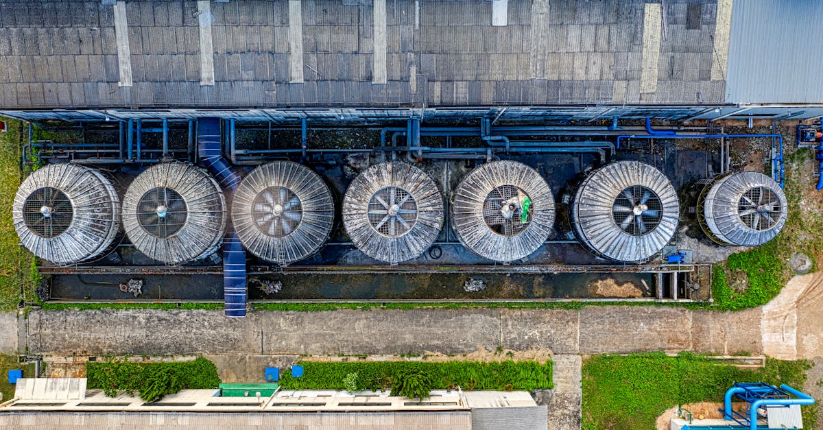 drone view of industrial terrain with treatment plants located in suburban area in sunlight